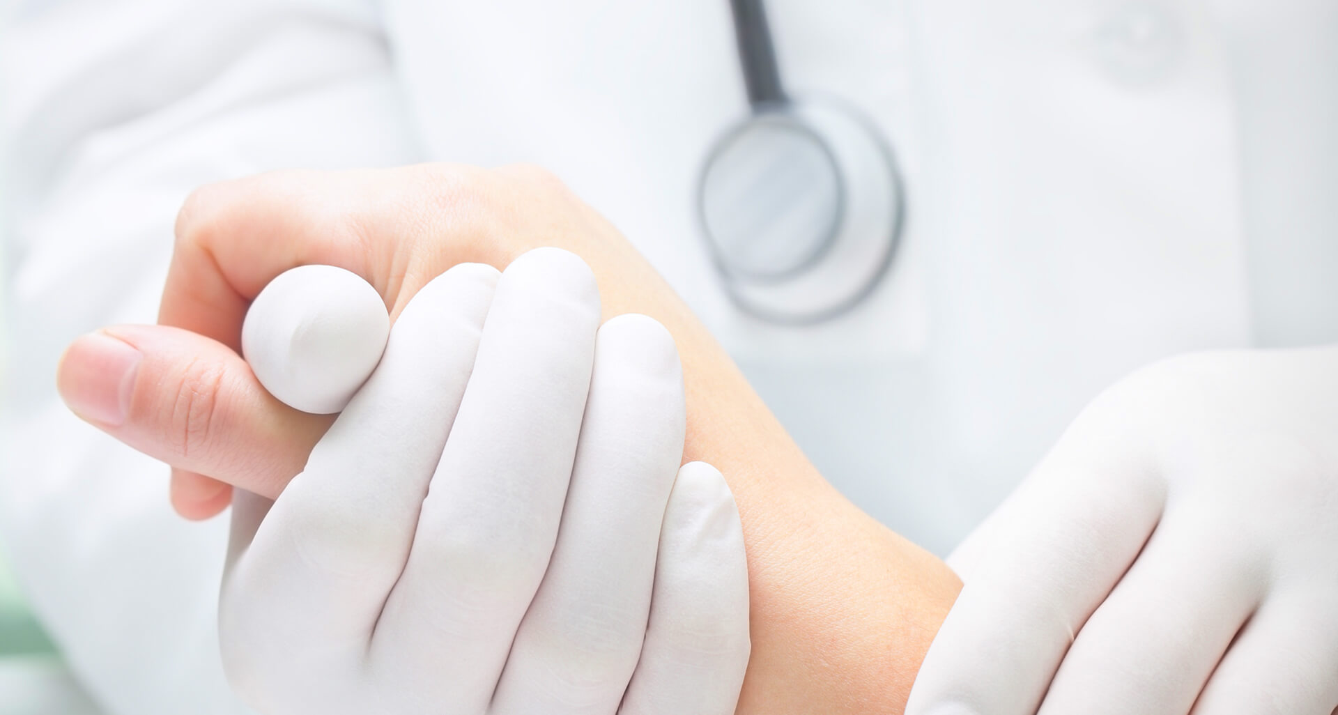 Doctor's hand holding a patient's hand